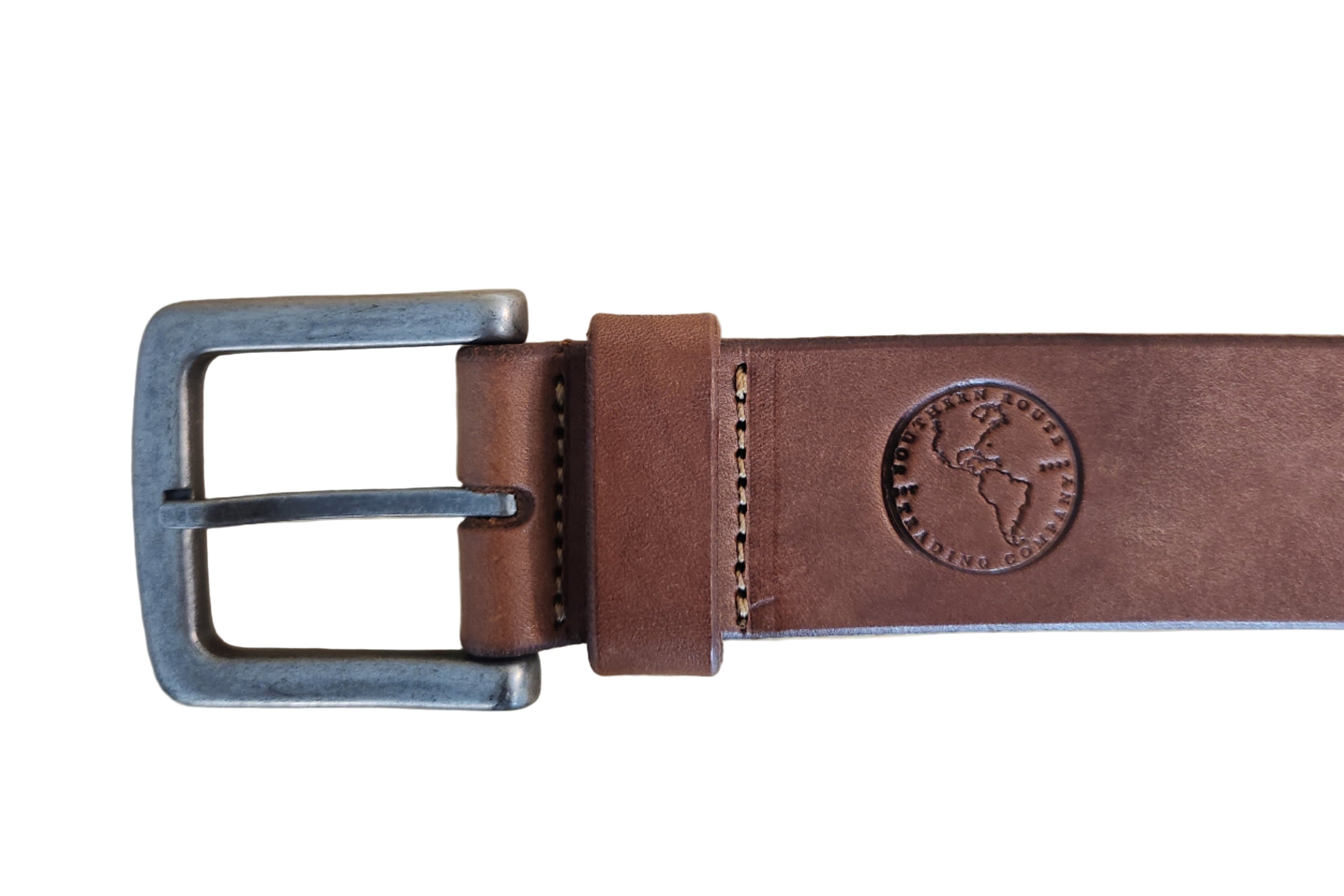 Brown leather belt with metal buckle on a wooden surface