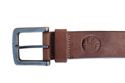 Brown leather belt with metal buckle on a wooden surface