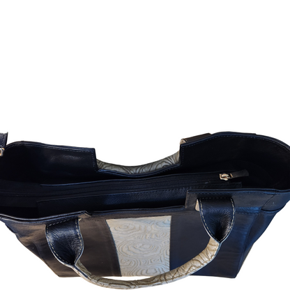 Navy blue handbag with a textured handle on a wooden surface