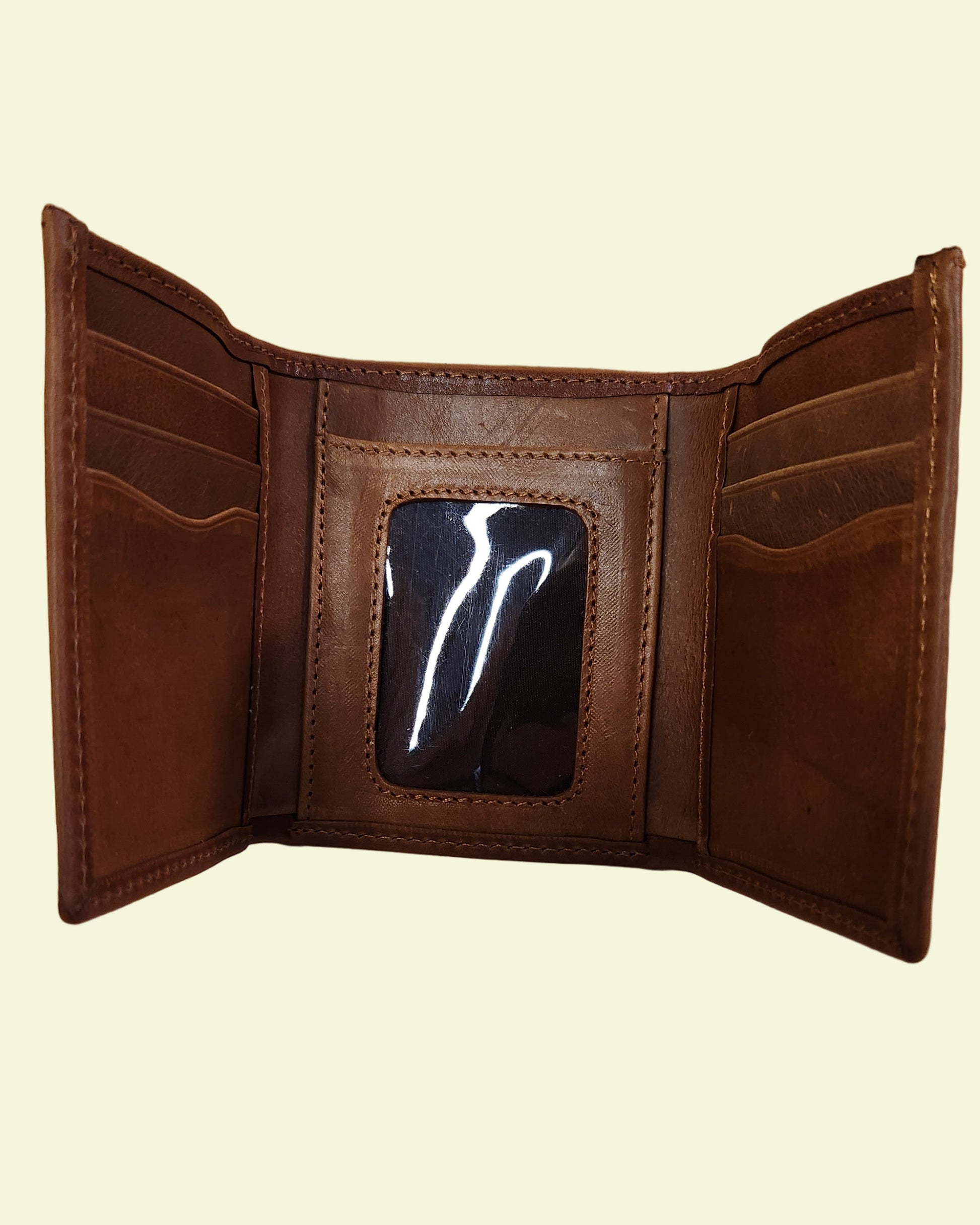 Brown leather wallet on a wooden surface