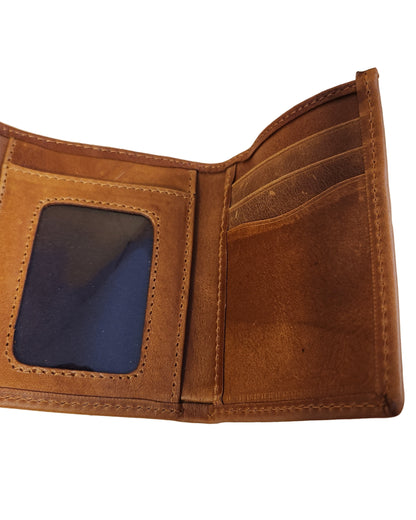 Brown leather wallet with a blue card holder on a beige background