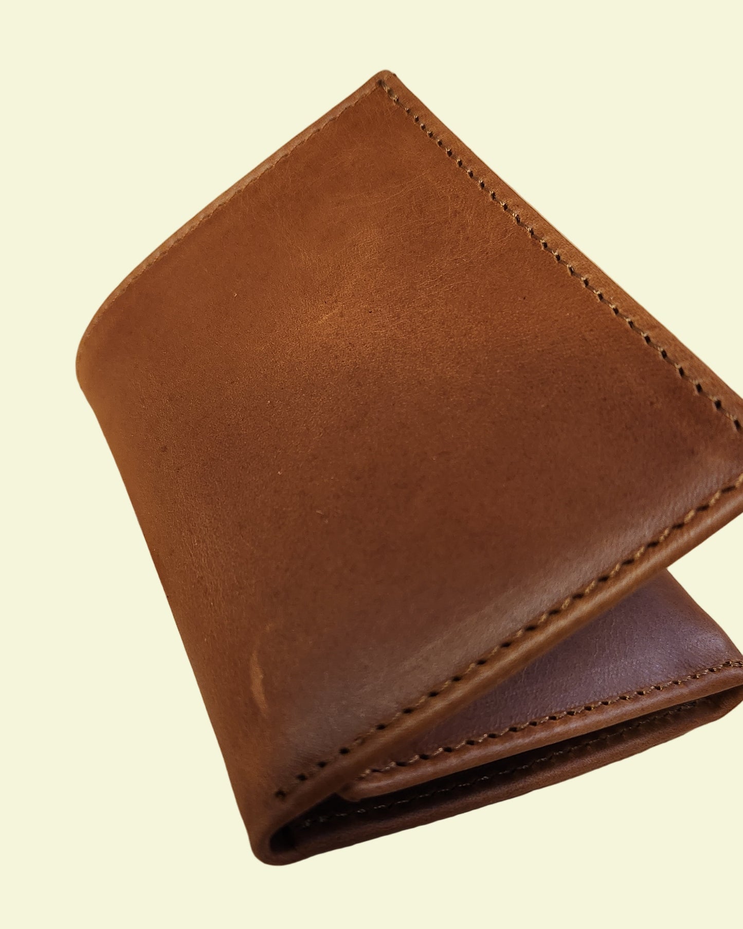 Brown leather wallet on a wooden surface