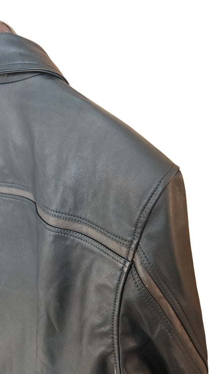 Close-up of a black leather jacket on a wooden surface