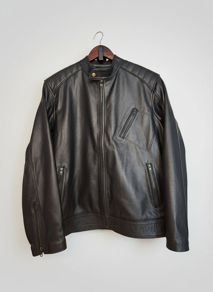 Black leather jacket on a wooden surface