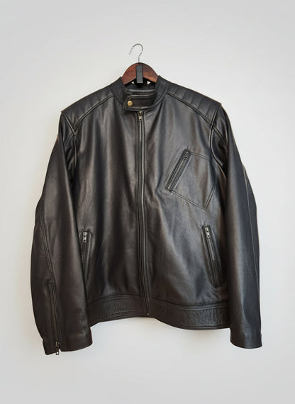 Black leather jacket on a wooden surface