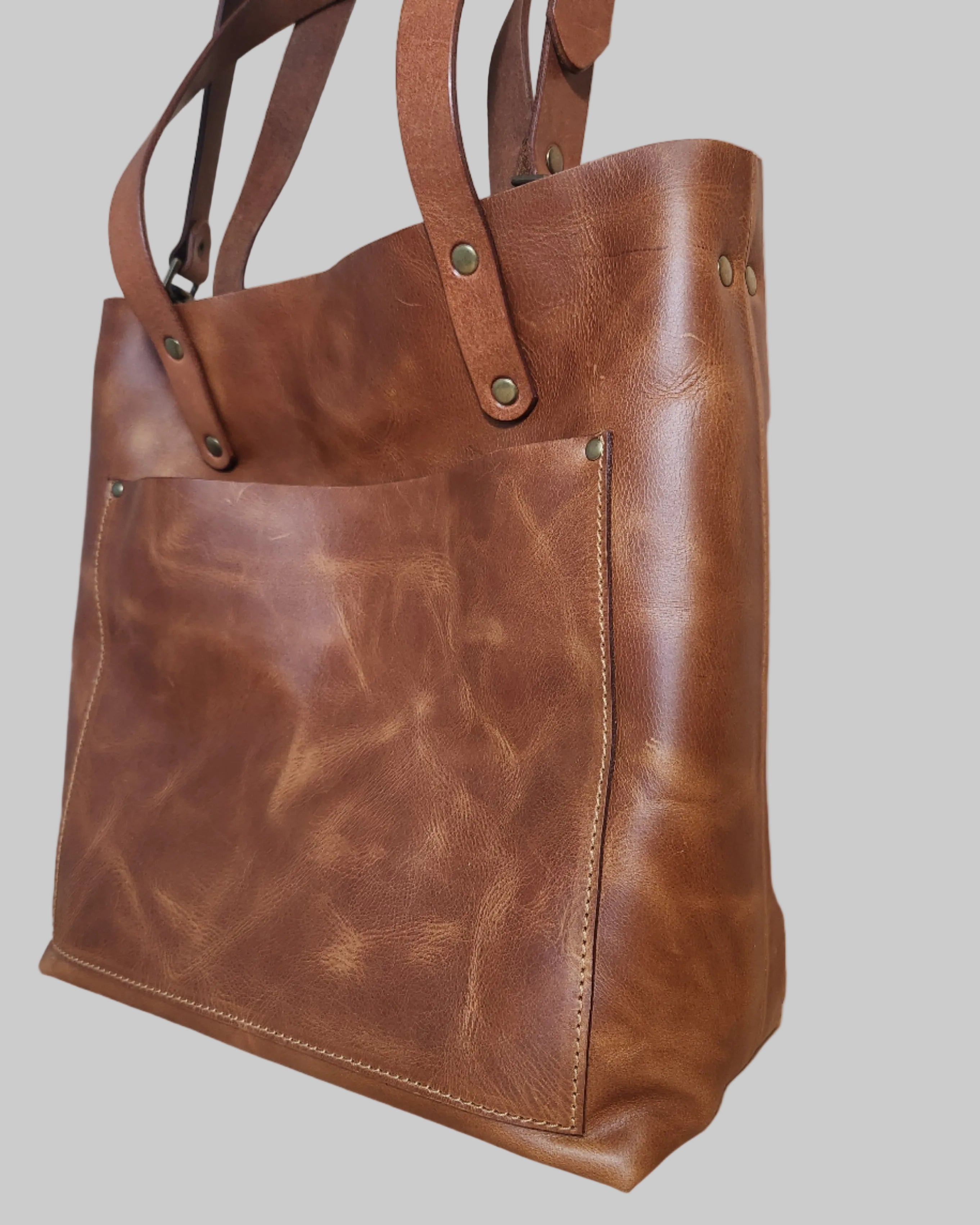 Brown leather bag on a wooden surface