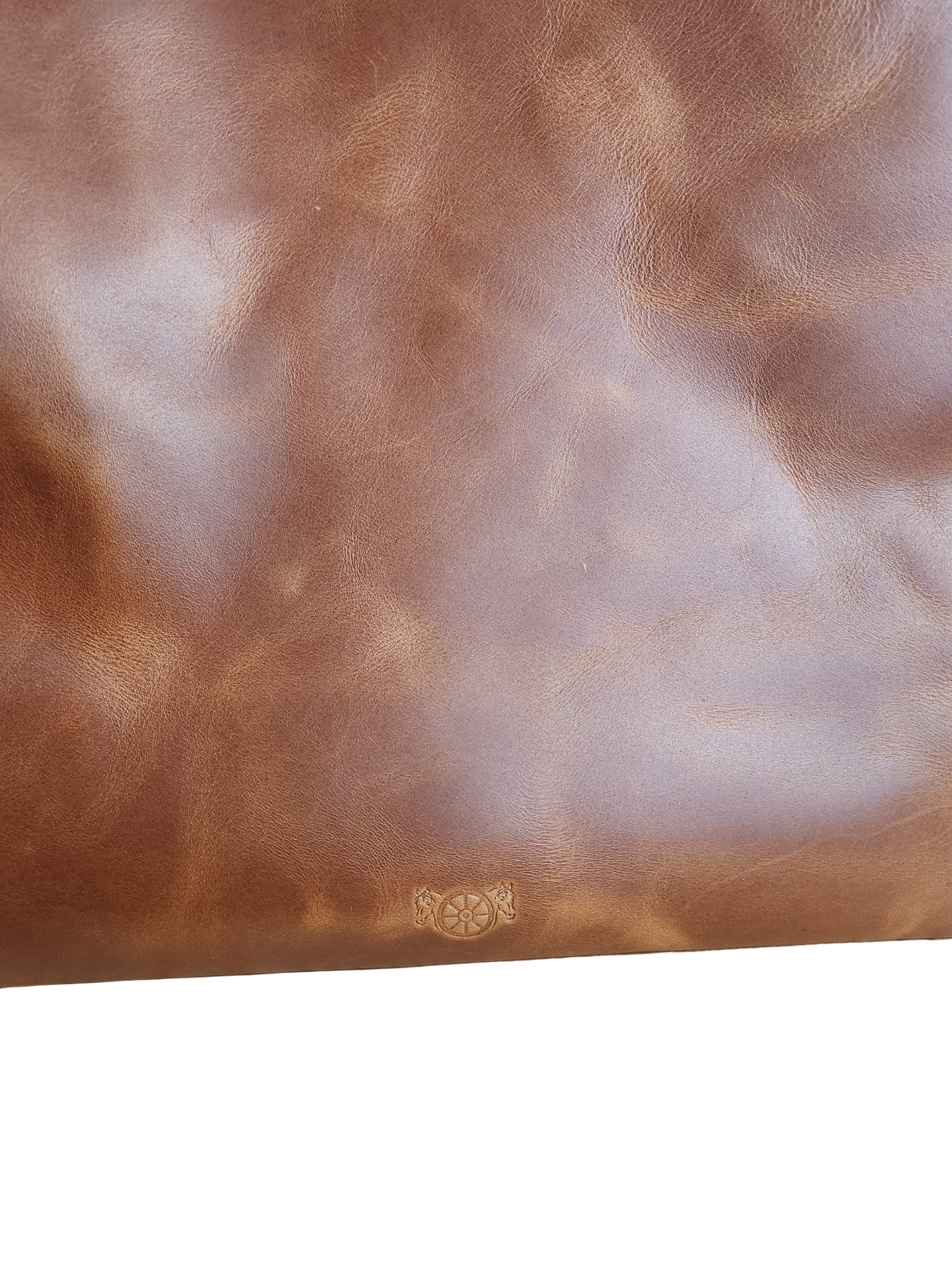 Brown leather surface with a subtle pattern on a wooden background