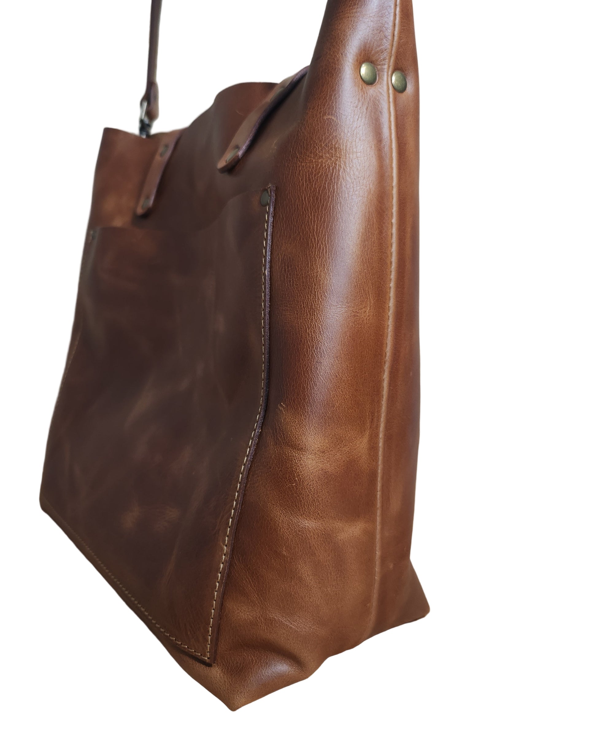 Brown leather bag on a wooden surface