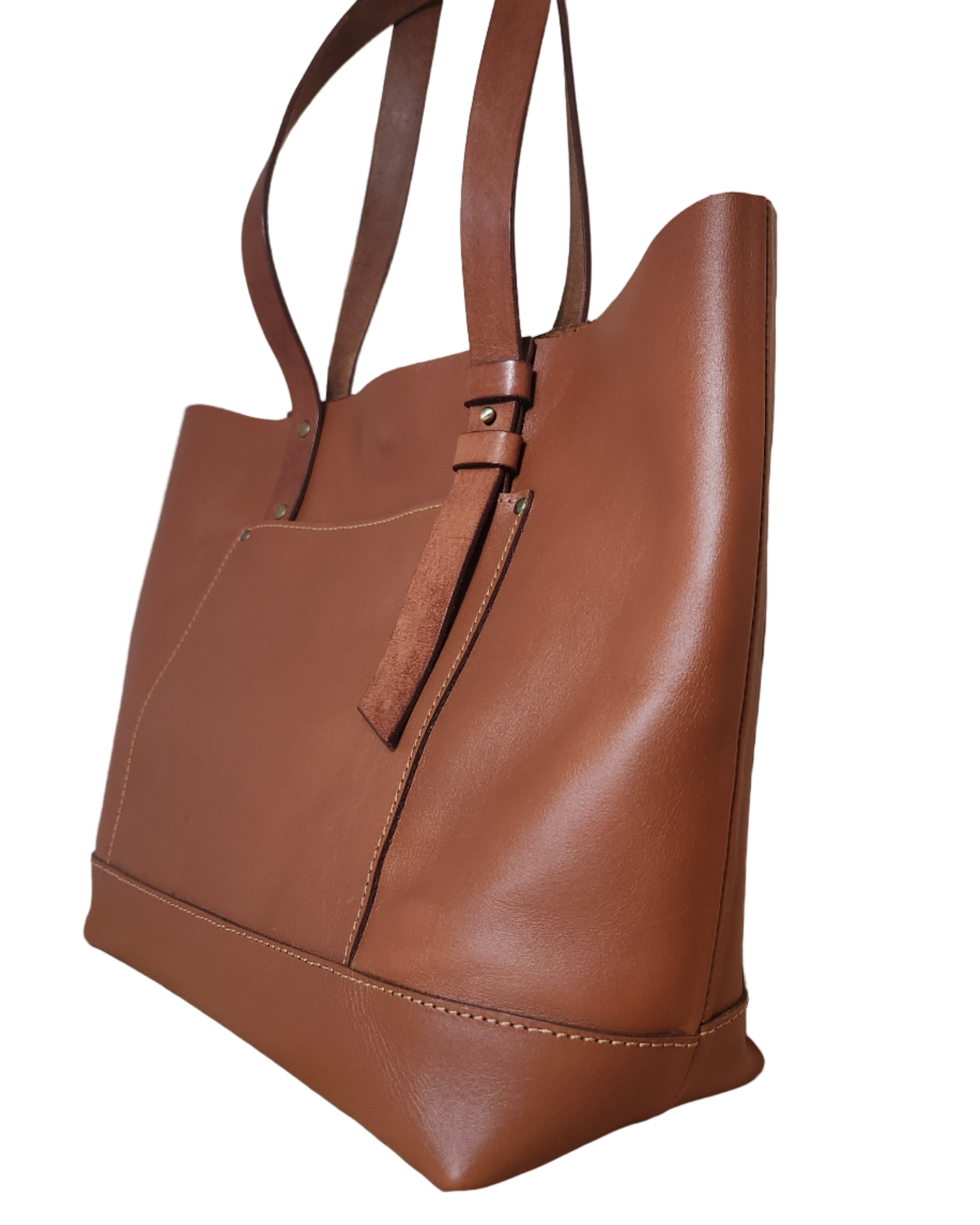 Brown leather handbag on a wooden surface