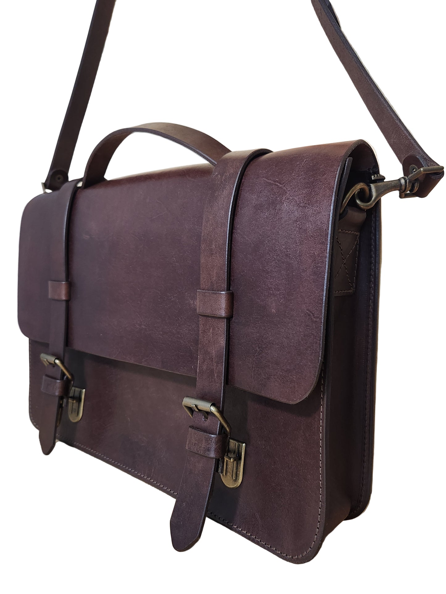 Brown leather bag on a wooden surface