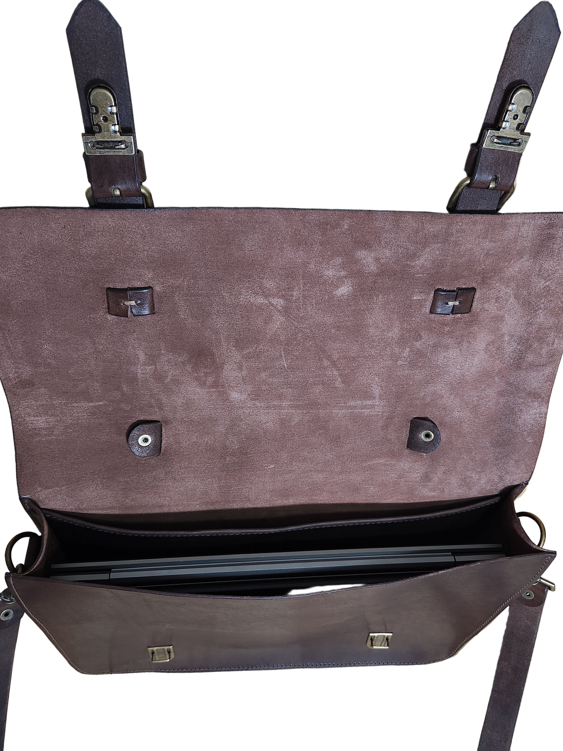 Brown leather briefcase with multiple buckles on a wooden surface