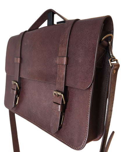 Brown leather briefcase on a wooden surface