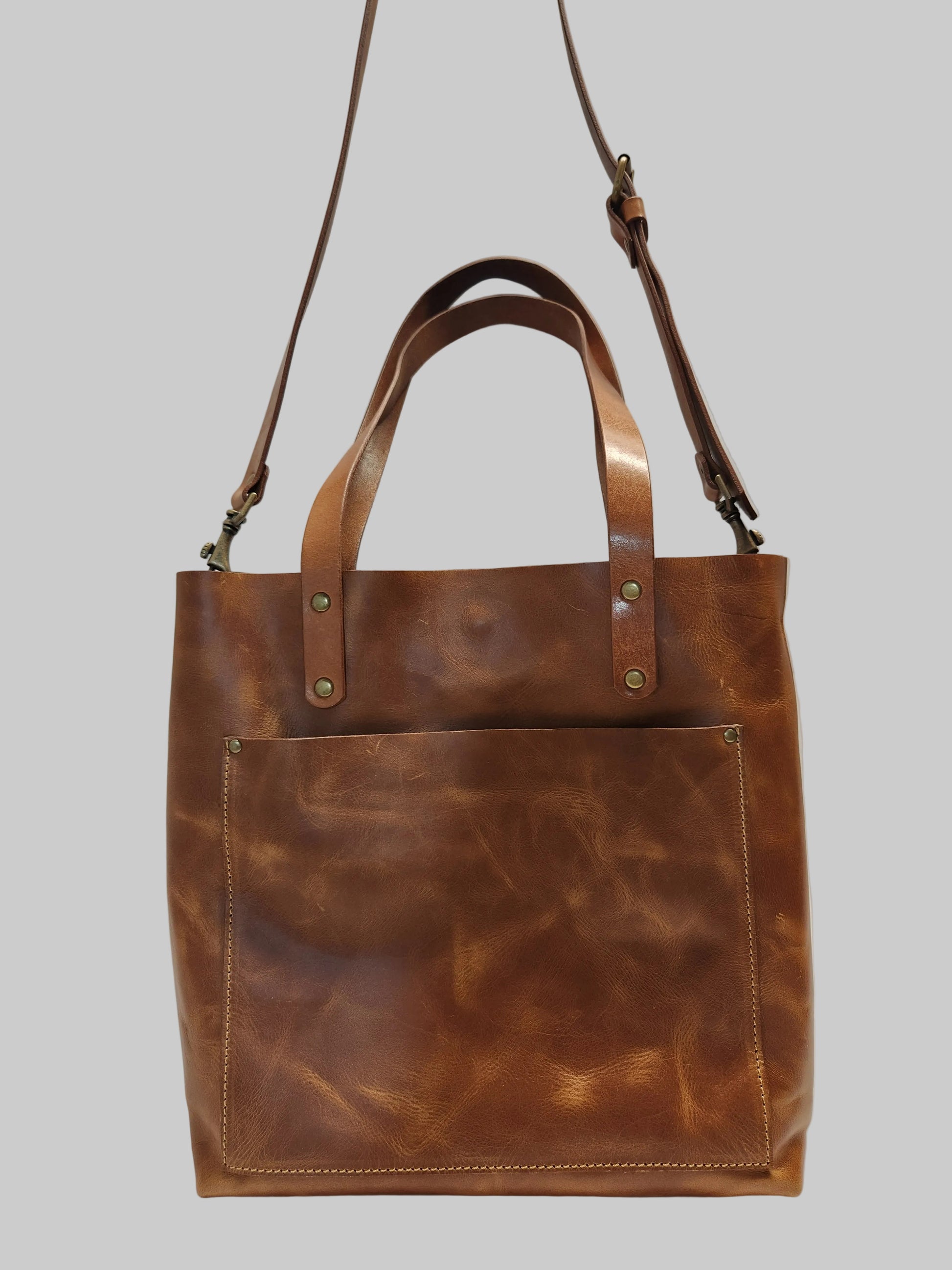 Brown leather tote bag on a white background