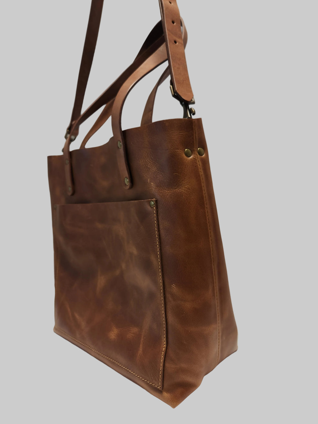 Brown leather bag on a light gray background