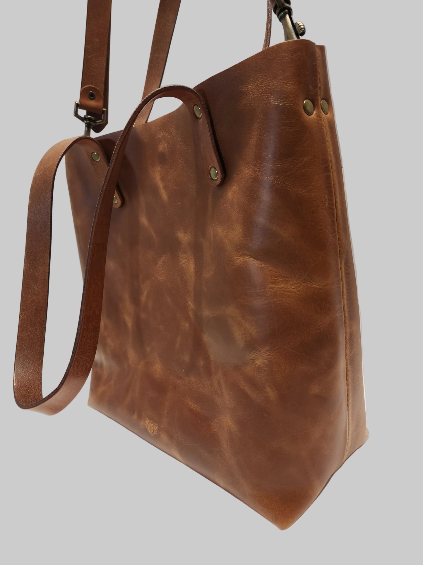 Brown leather handbag on a light background