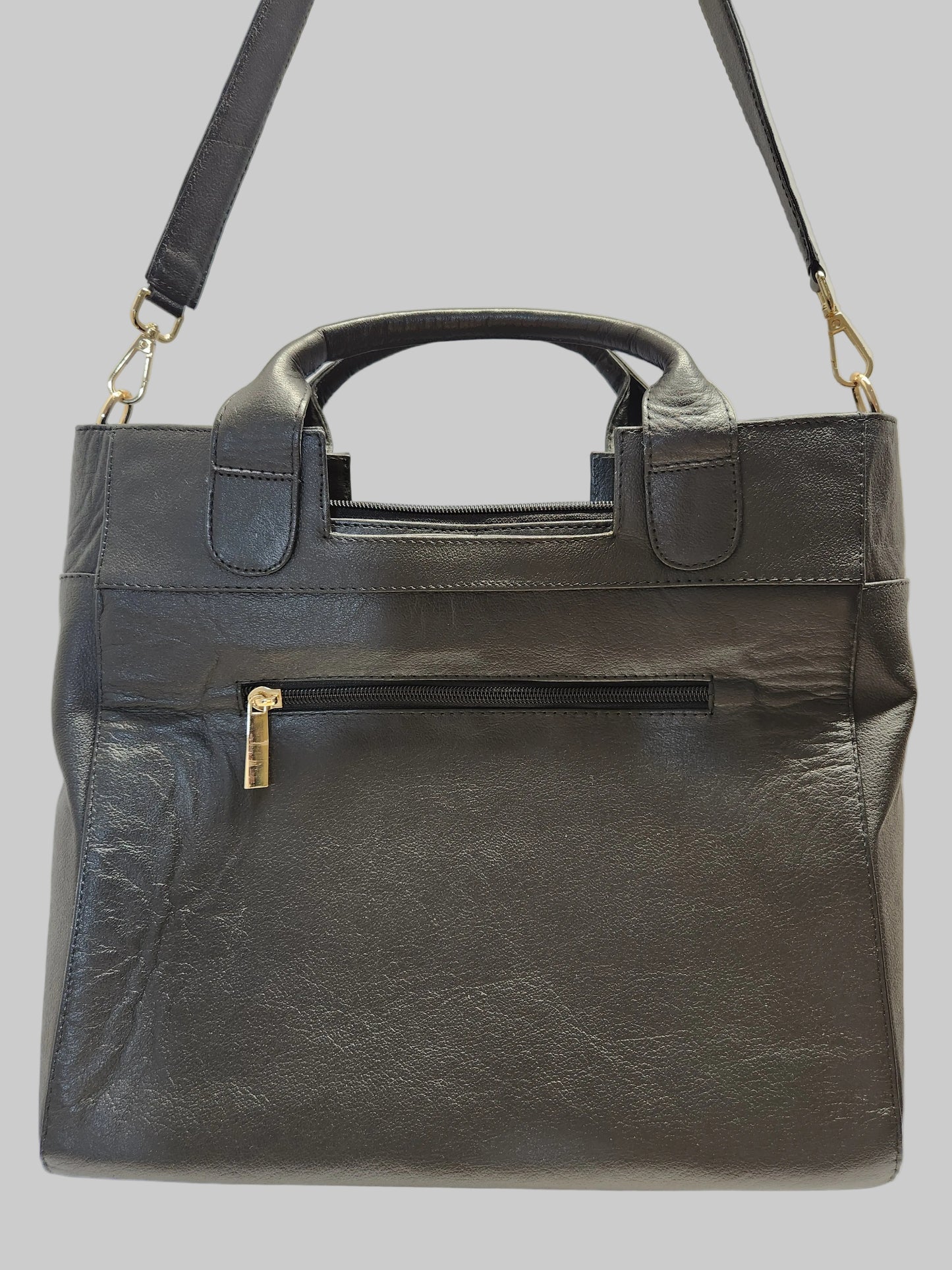 Black leather briefcase with gold hardware on a light gray background