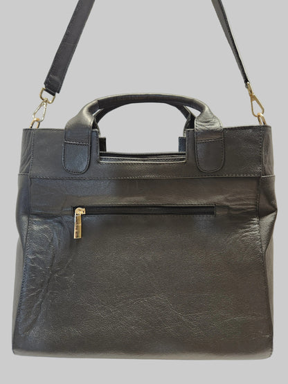 Black leather briefcase with gold hardware on a light gray background