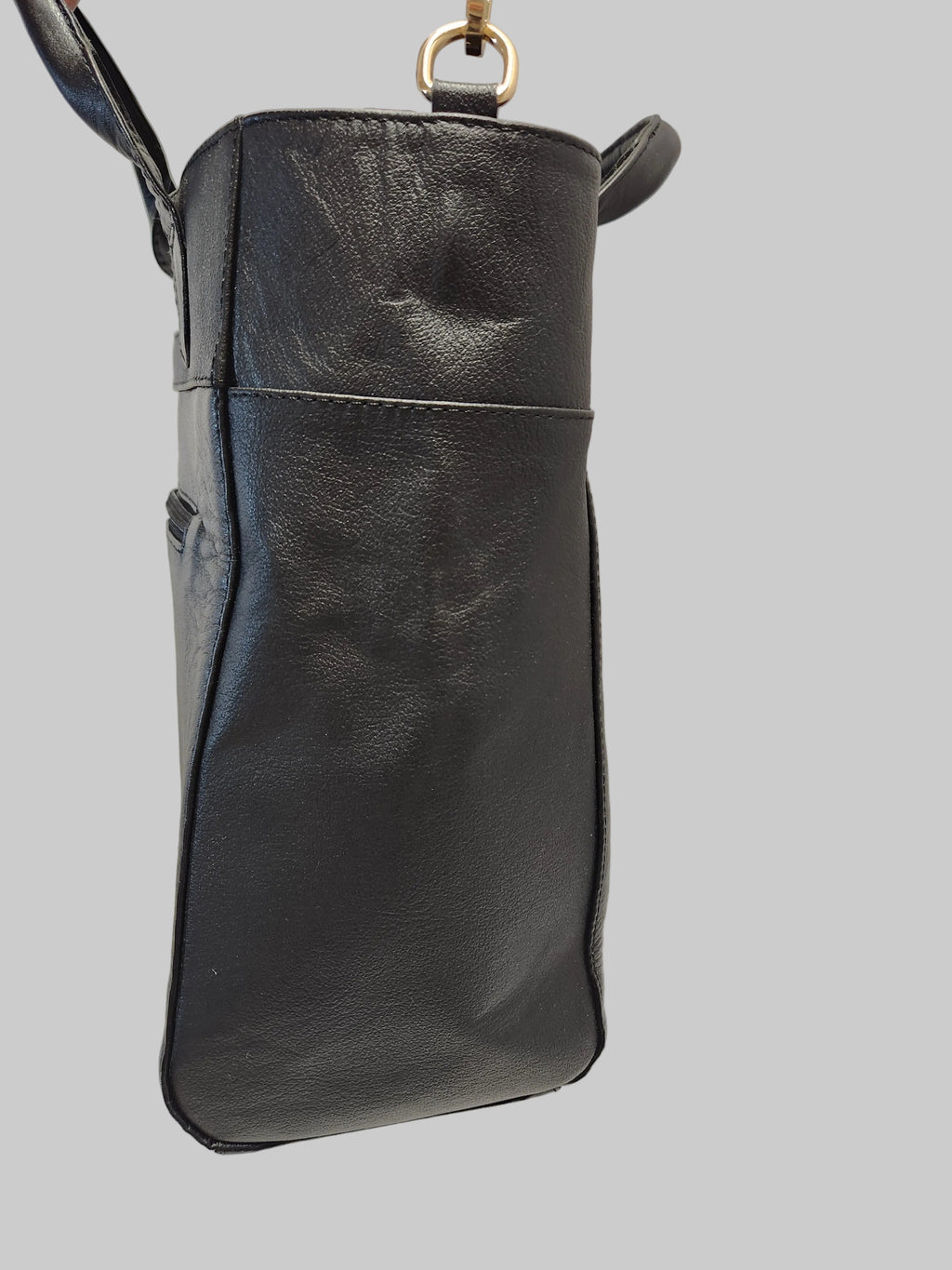 Black leather handbag on a light gray background