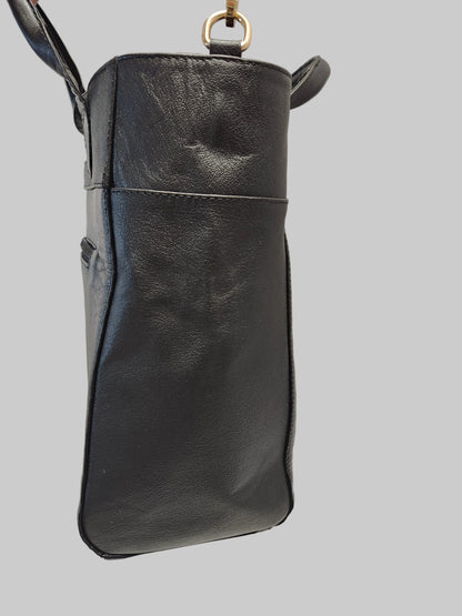 Black leather handbag on a light gray background
