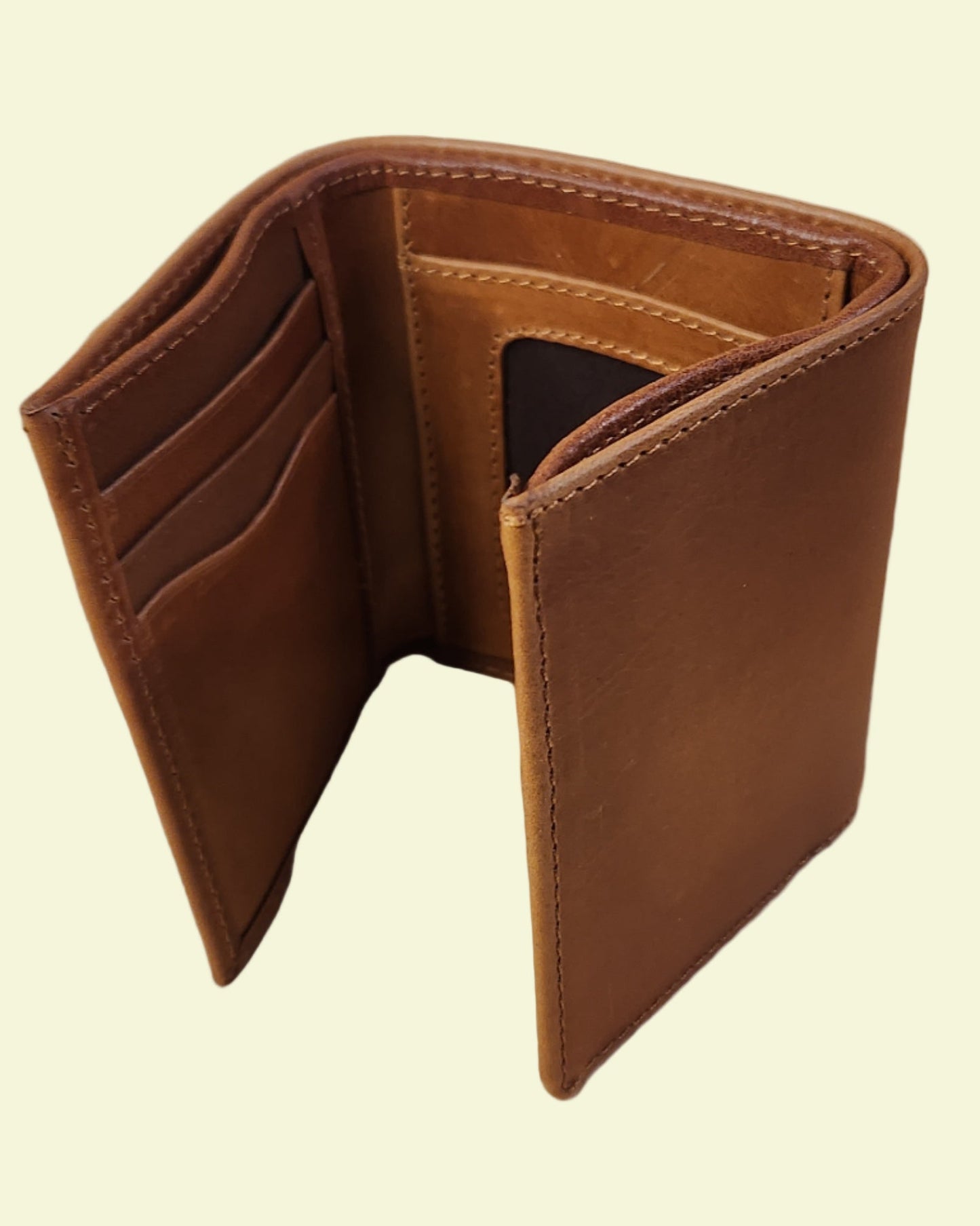 Brown leather wallet on a wooden surface