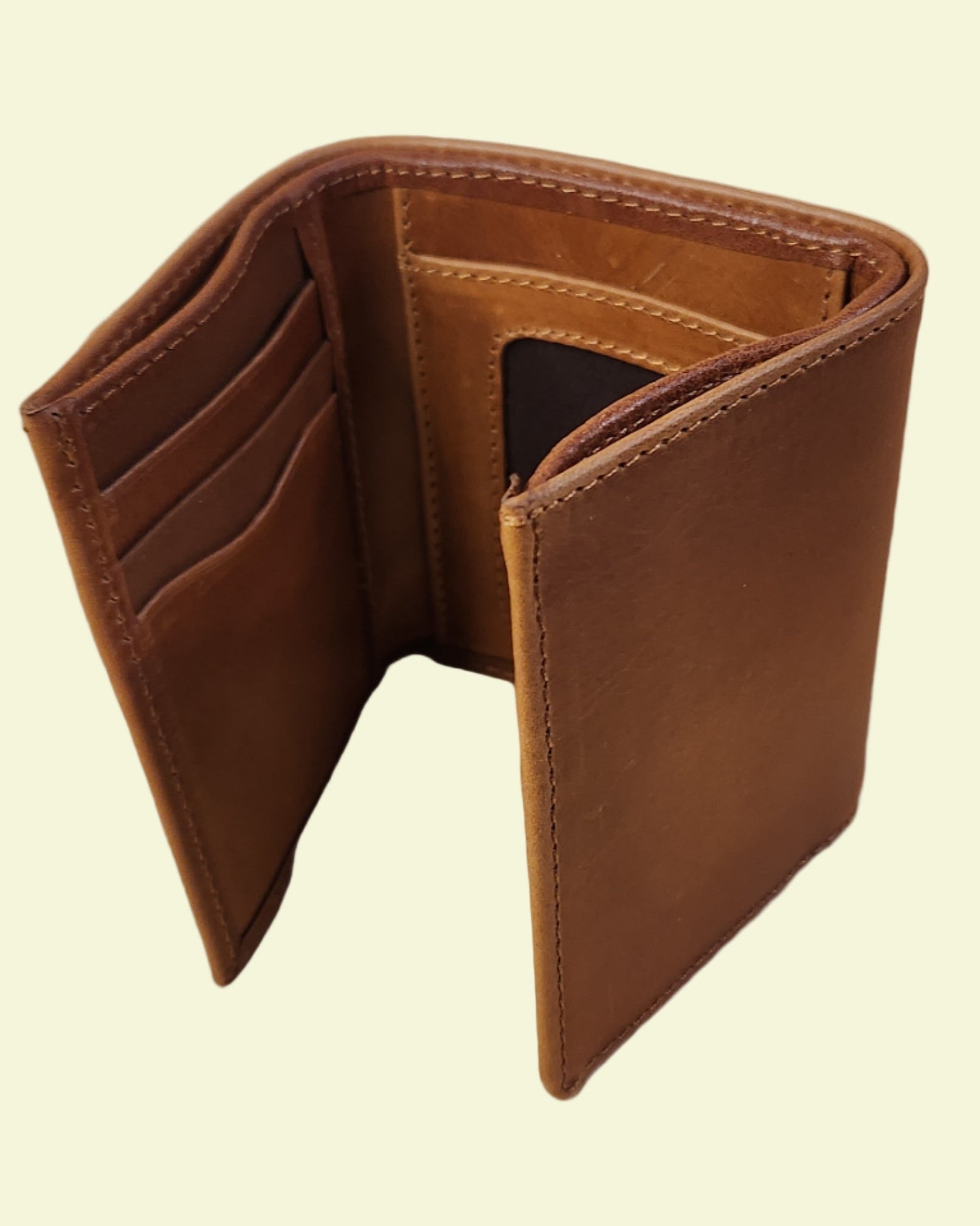 Brown leather wallet on a wooden surface