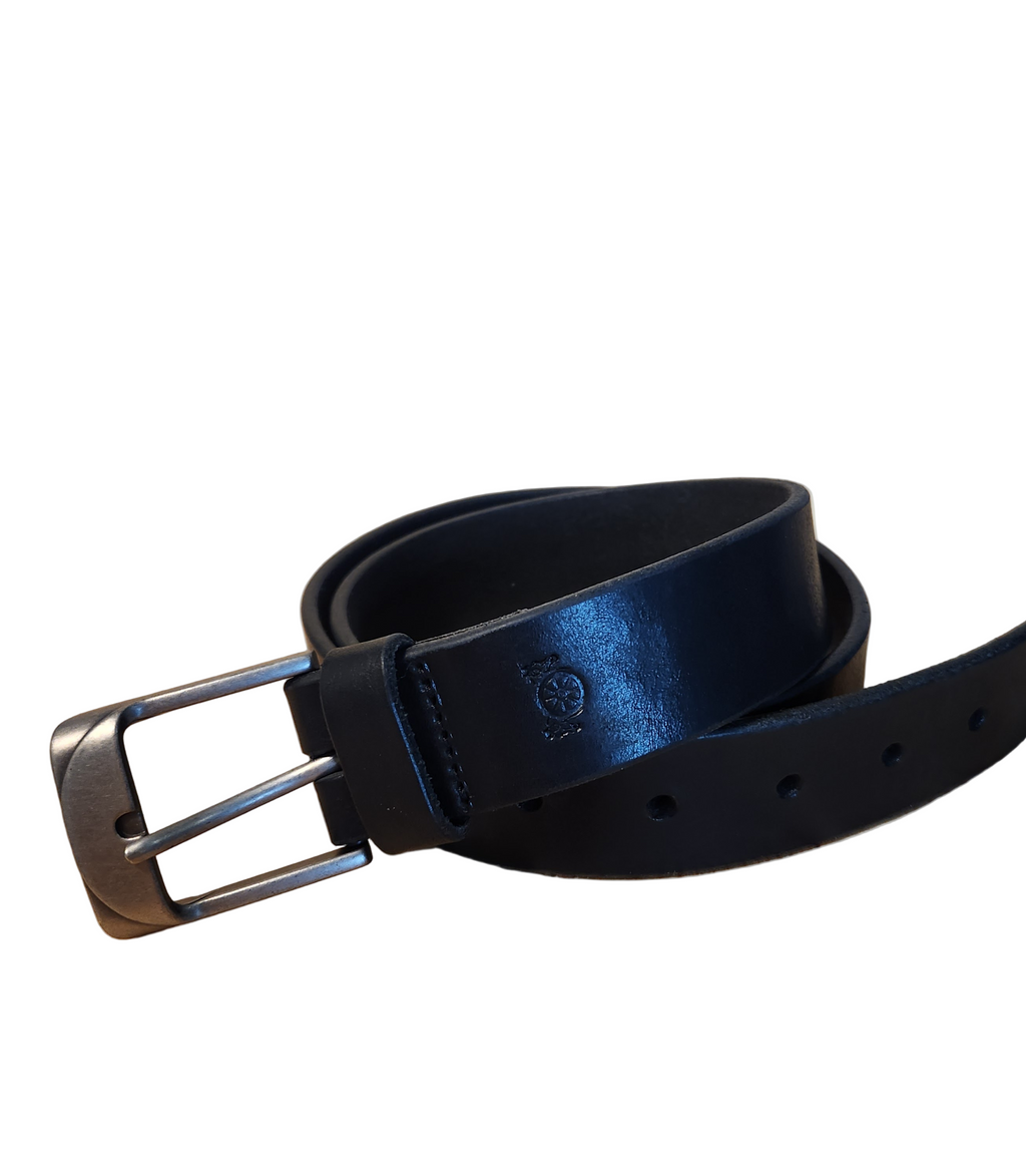 Black leather belt with silver buckle on a wooden surface