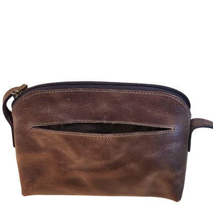Brown leather pouch on a wooden surface