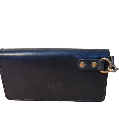 Black leather clutch bag with gold accents on a gray background