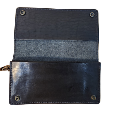 Black leather wallet with a textured interior on a beige background
