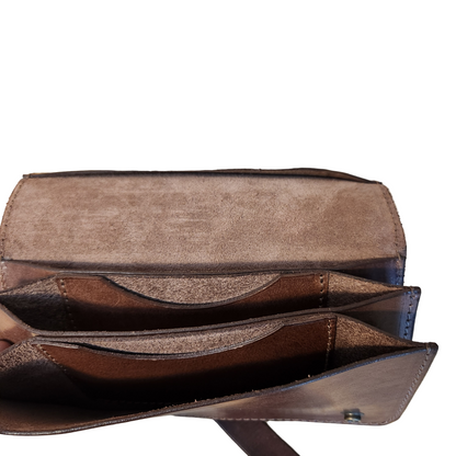 Brown leather wallet open on a wooden surface
