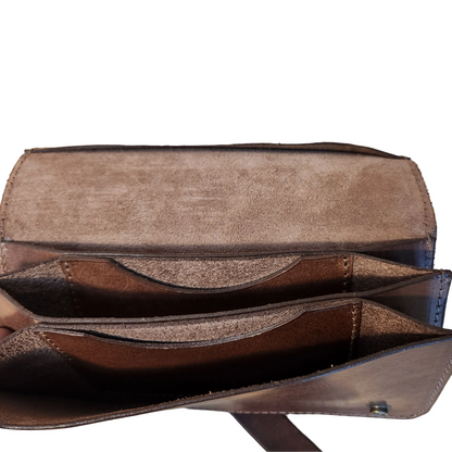 Brown leather wallet open on a wooden surface