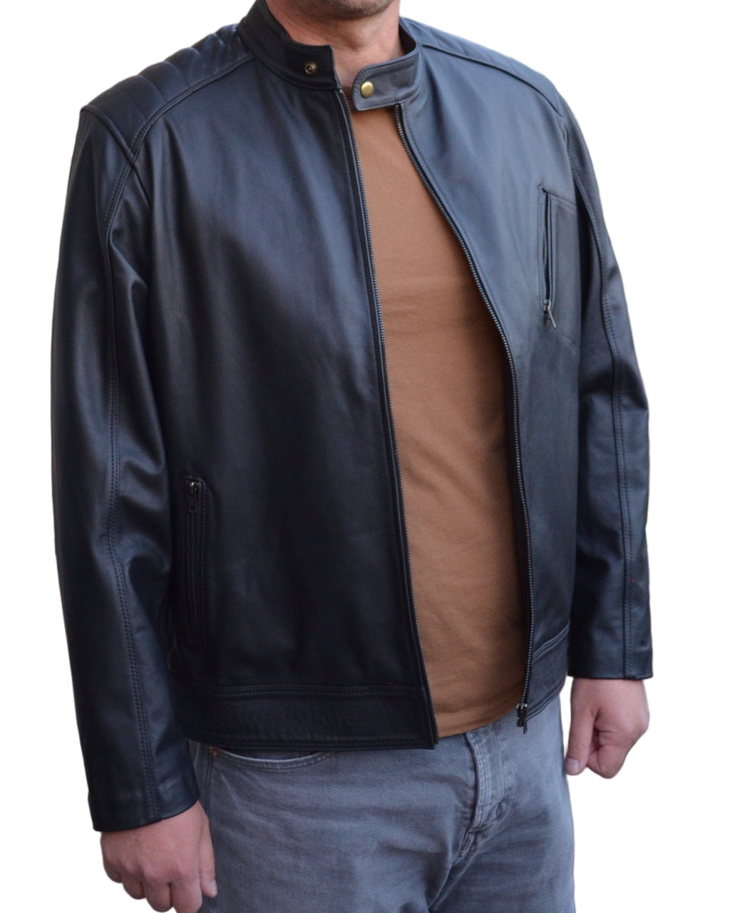 Man wearing a black leather jacket standing outside a house