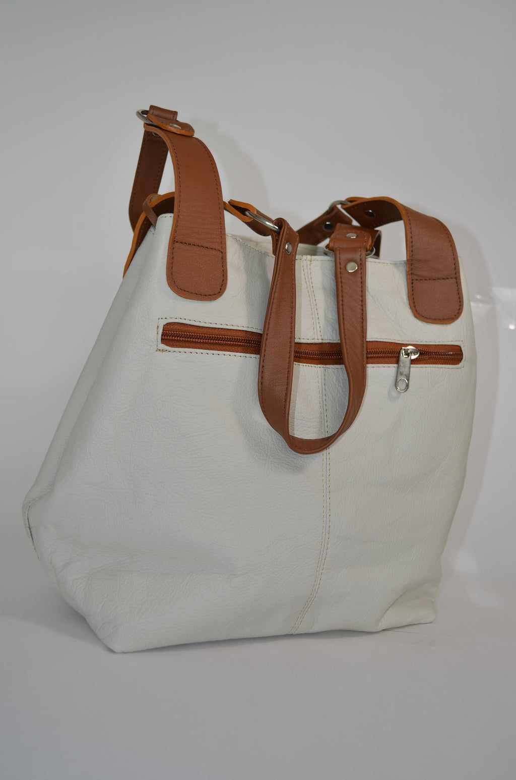 White bag with brown straps on a white background