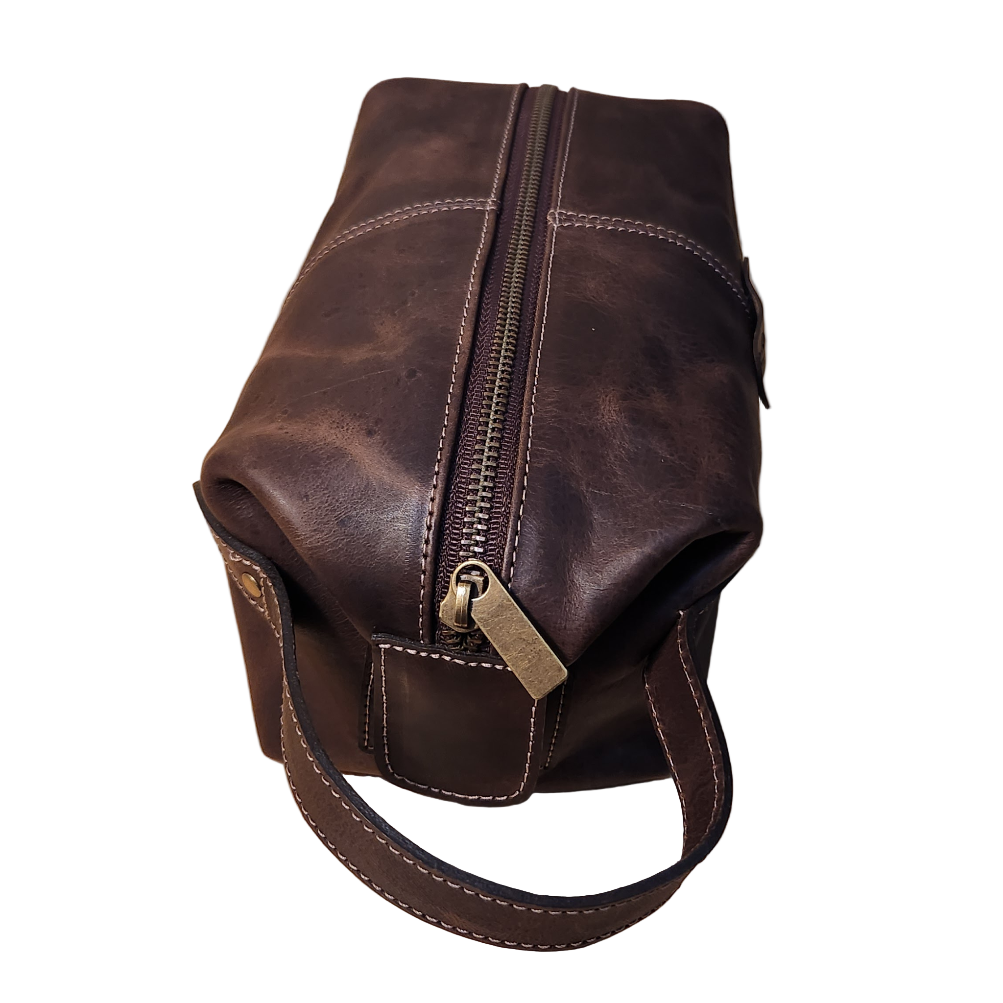 Brown leather bag with a zipper on a wooden surface