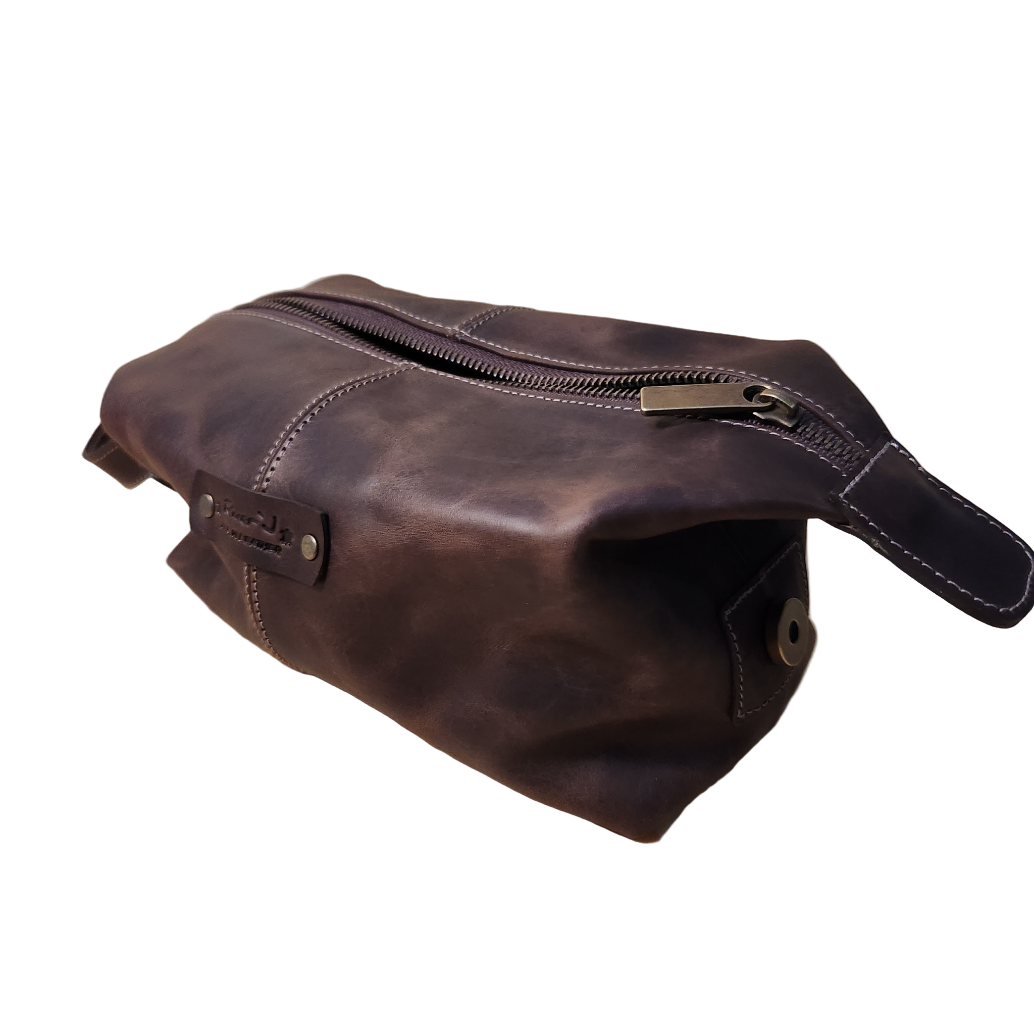 Brown leather dopp kit with a zipper on a white background