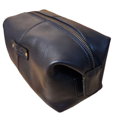 Black leather toiletry bag with zipper on a white background