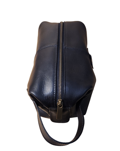 Black leather bag with a zipper on a wooden surface