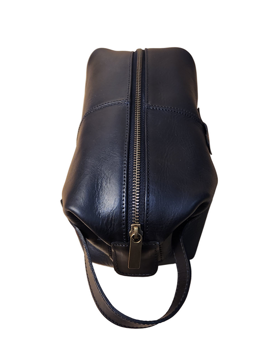 Black leather bag with a zipper on a wooden surface