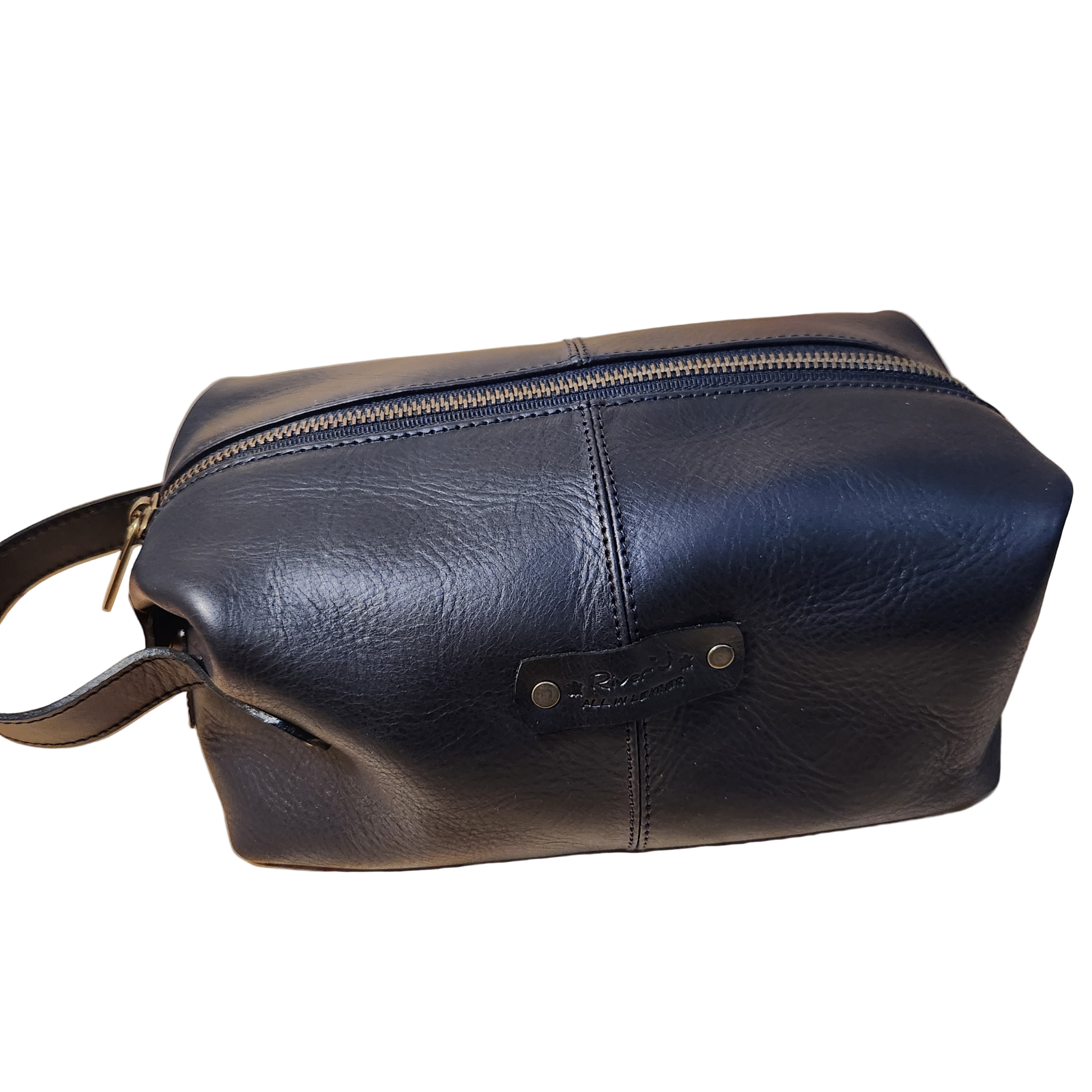 Black leather toiletry bag with a handle on a wooden surface