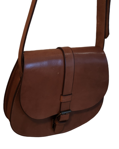 Brown leather bag on a wooden surface