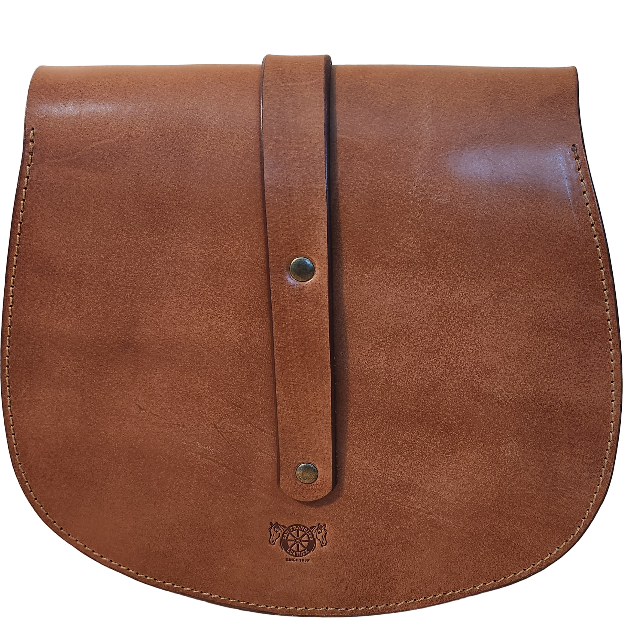 Brown leather bag with a strap on a wooden surface