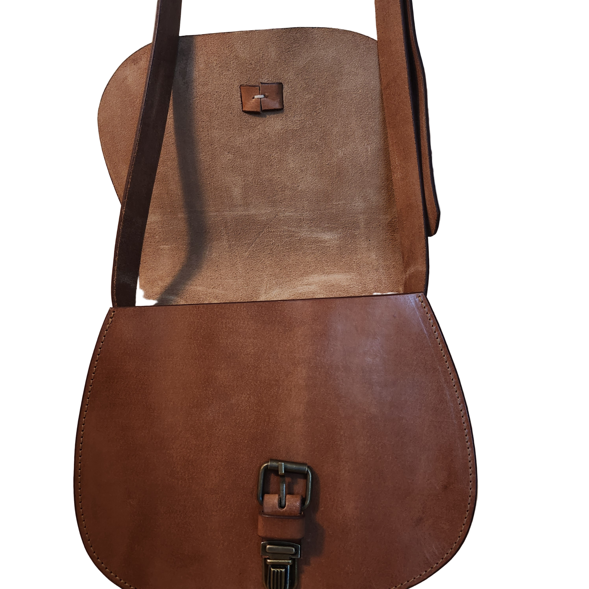 Brown leather bag with a strap on a wooden surface