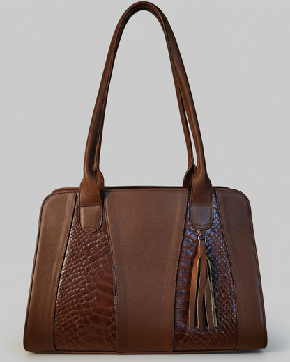 Brown leather handbag with textured pattern on a wooden surface