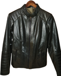 Emerald leather jacket on a wooden hanger against a blurred indoor background