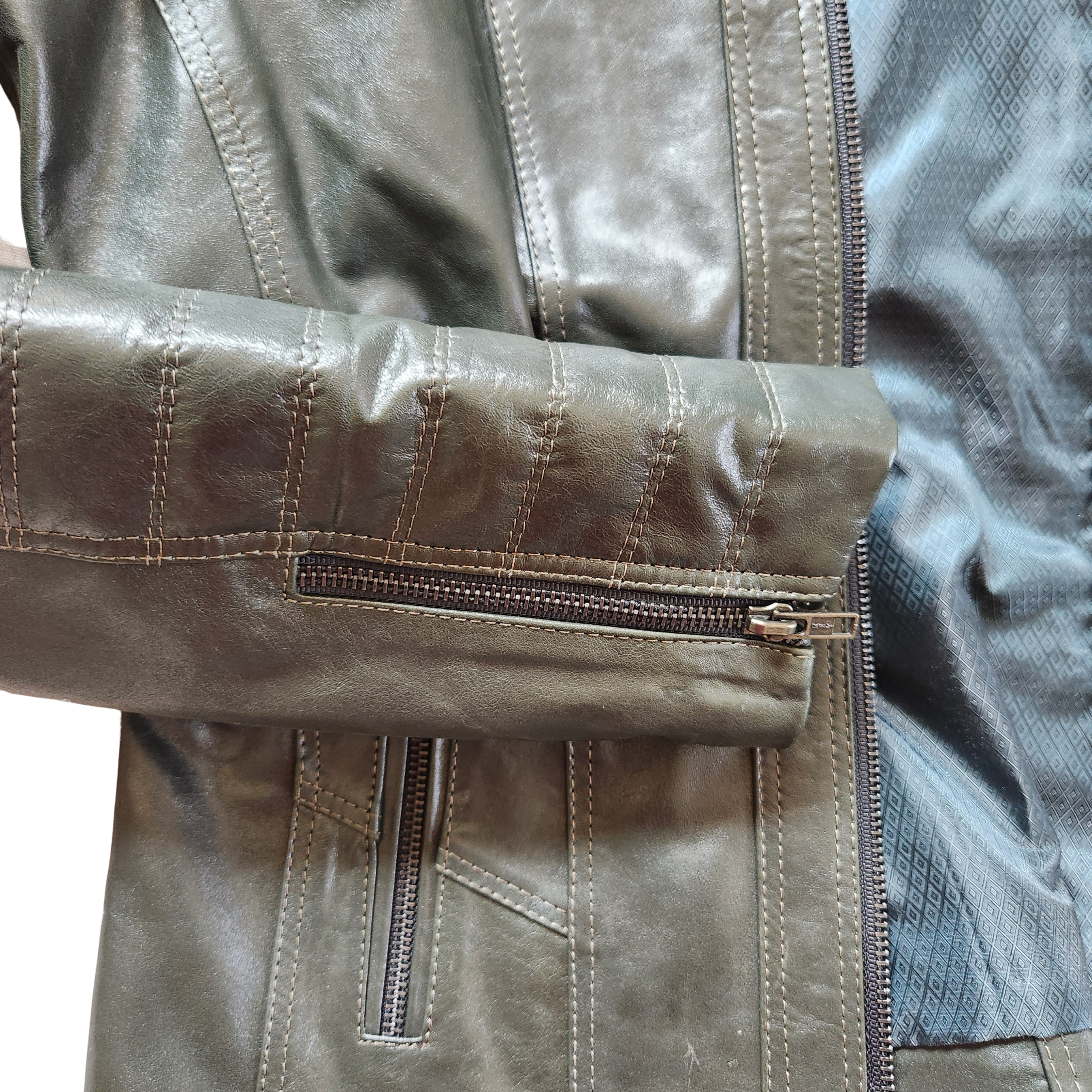Close-up of a brown leather jacket with a zipper