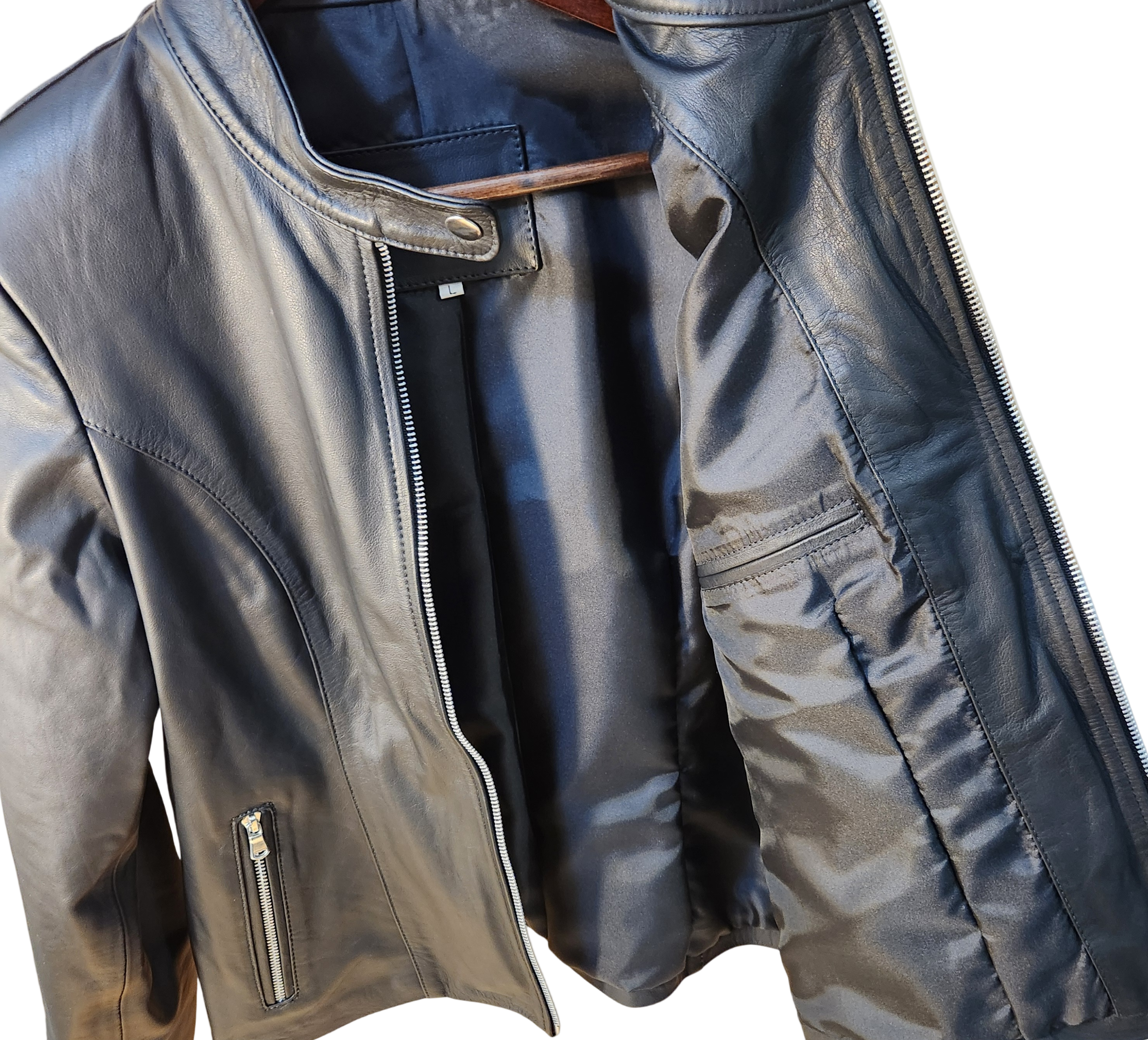Close-up of a black leather jacket with zippers on a white background