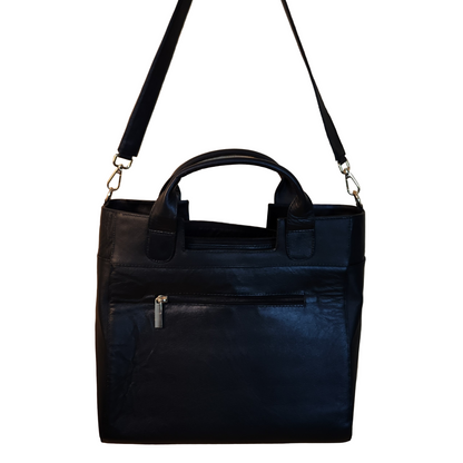 Black leather handbag with a shoulder strap on a wooden surface