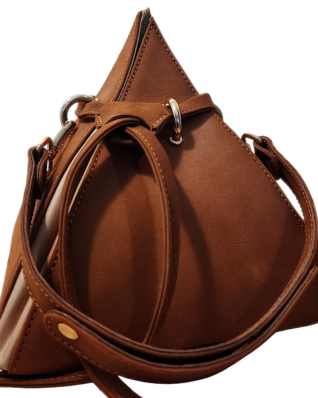 Brown leather handbag with a strap on a light background