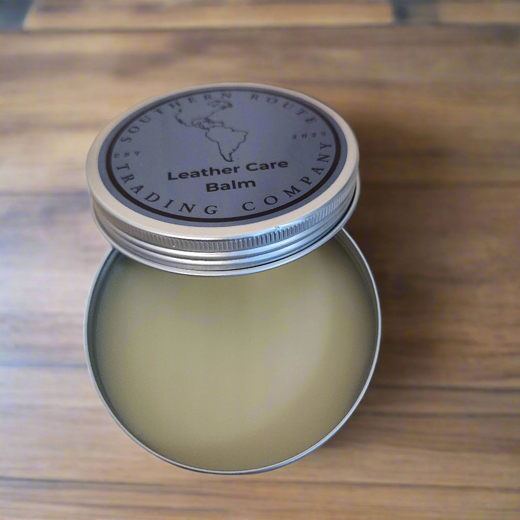 Open tin of leather care balm on a wooden surface
