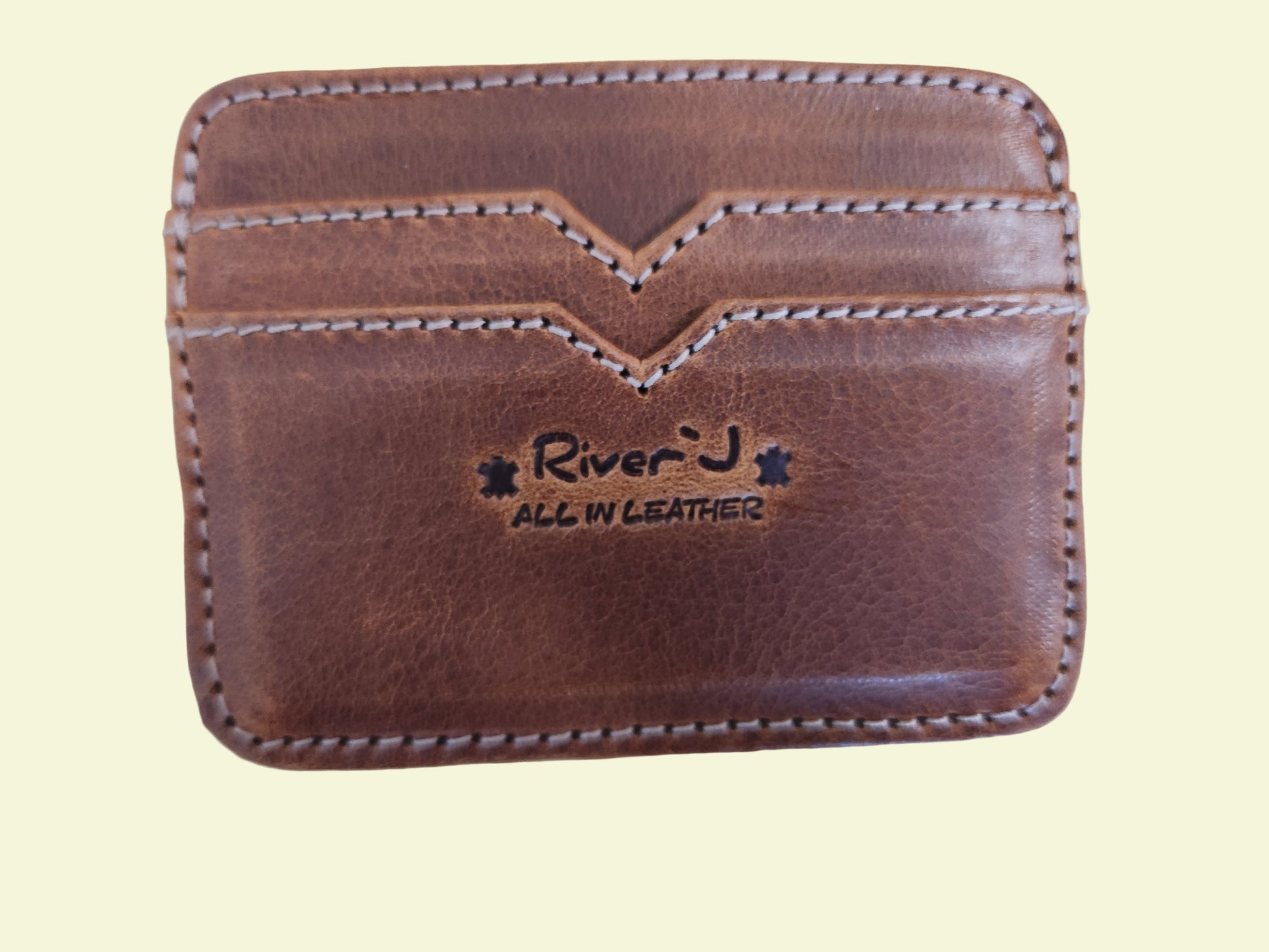 Brown leather wallet with 'River J' branding on a wooden surface